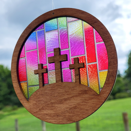 wooden suncatcher featuring 3 crosses on a hill with transparent acrylic "stained glass" background. 